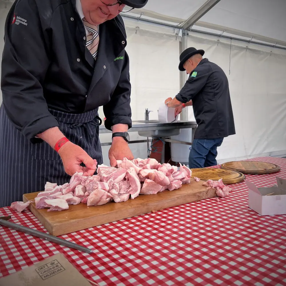 Butchers working with raw meat