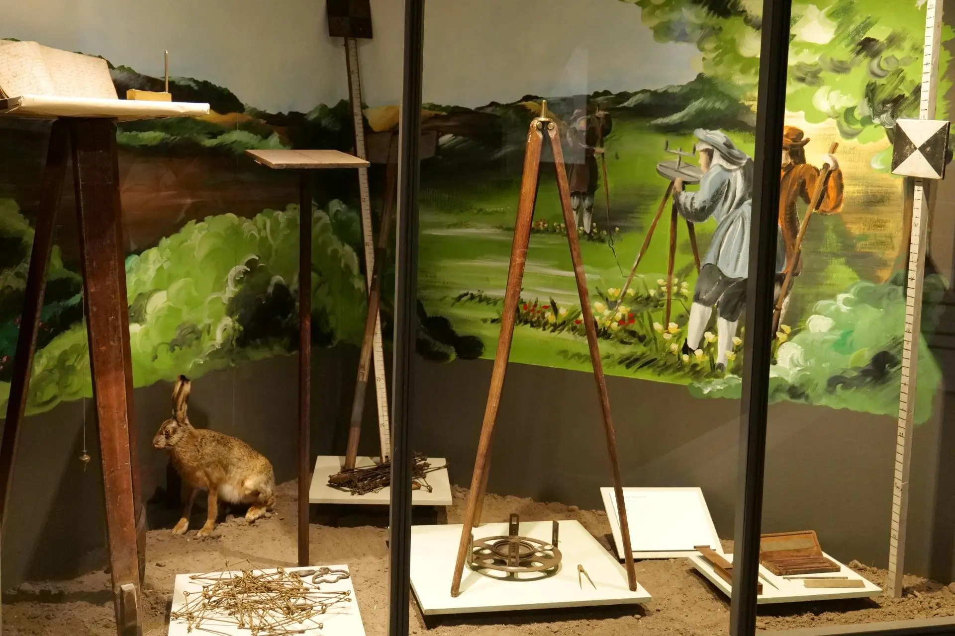 Surveying equipment The picture shows surveying equipment standing in a display case in the Farm Life exhibition at the Green Museum.