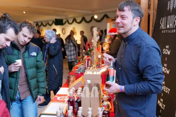 Guests look at one of the stalls at the Christmas market